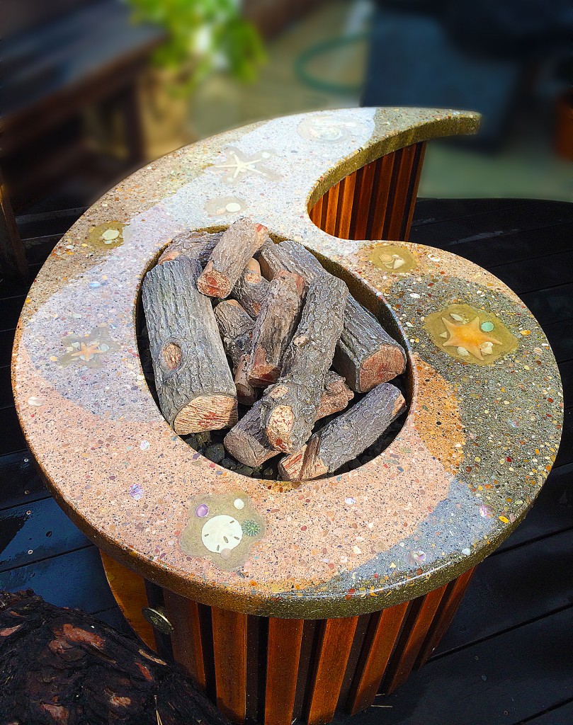 Custom handmade concrete fire pit/table with submersed seashell in resin.